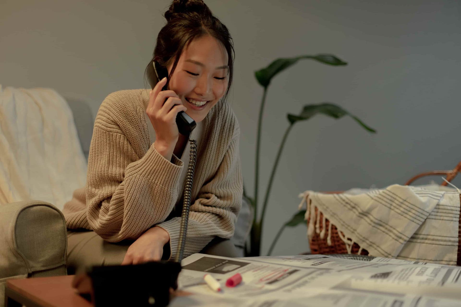Someone calling a company while looking at job posts.