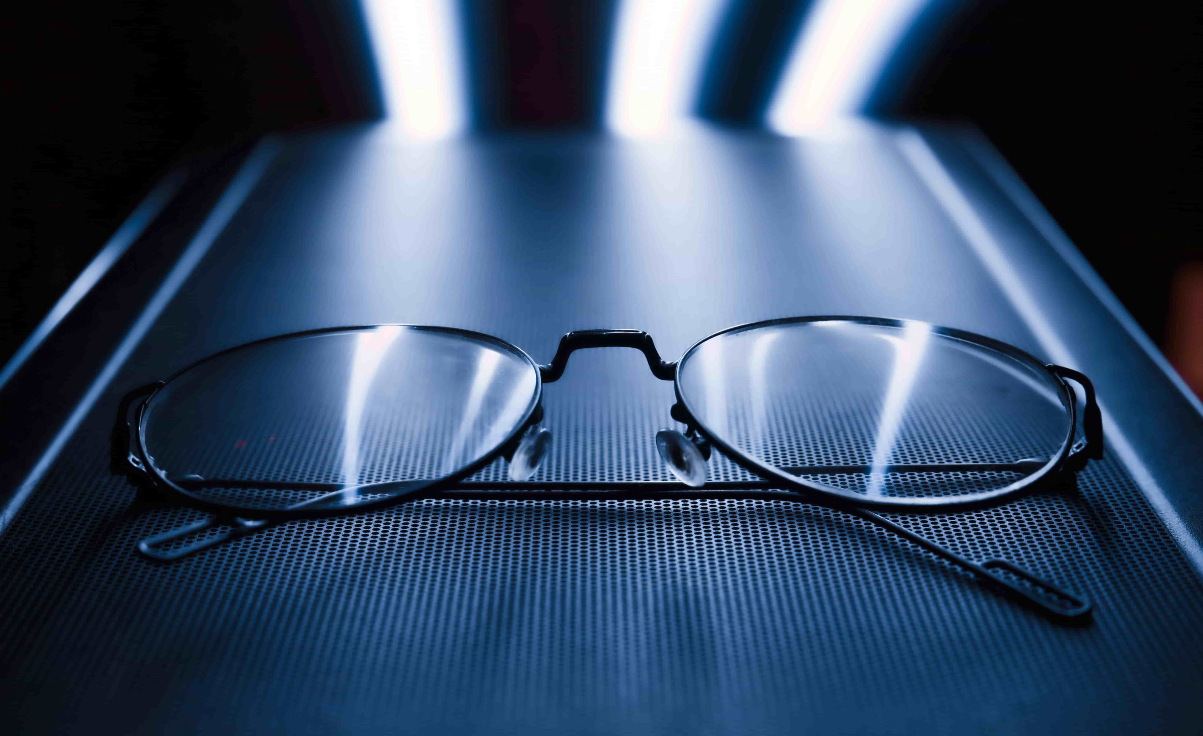 Person wearing blue-light-filtering glasses while using a computer