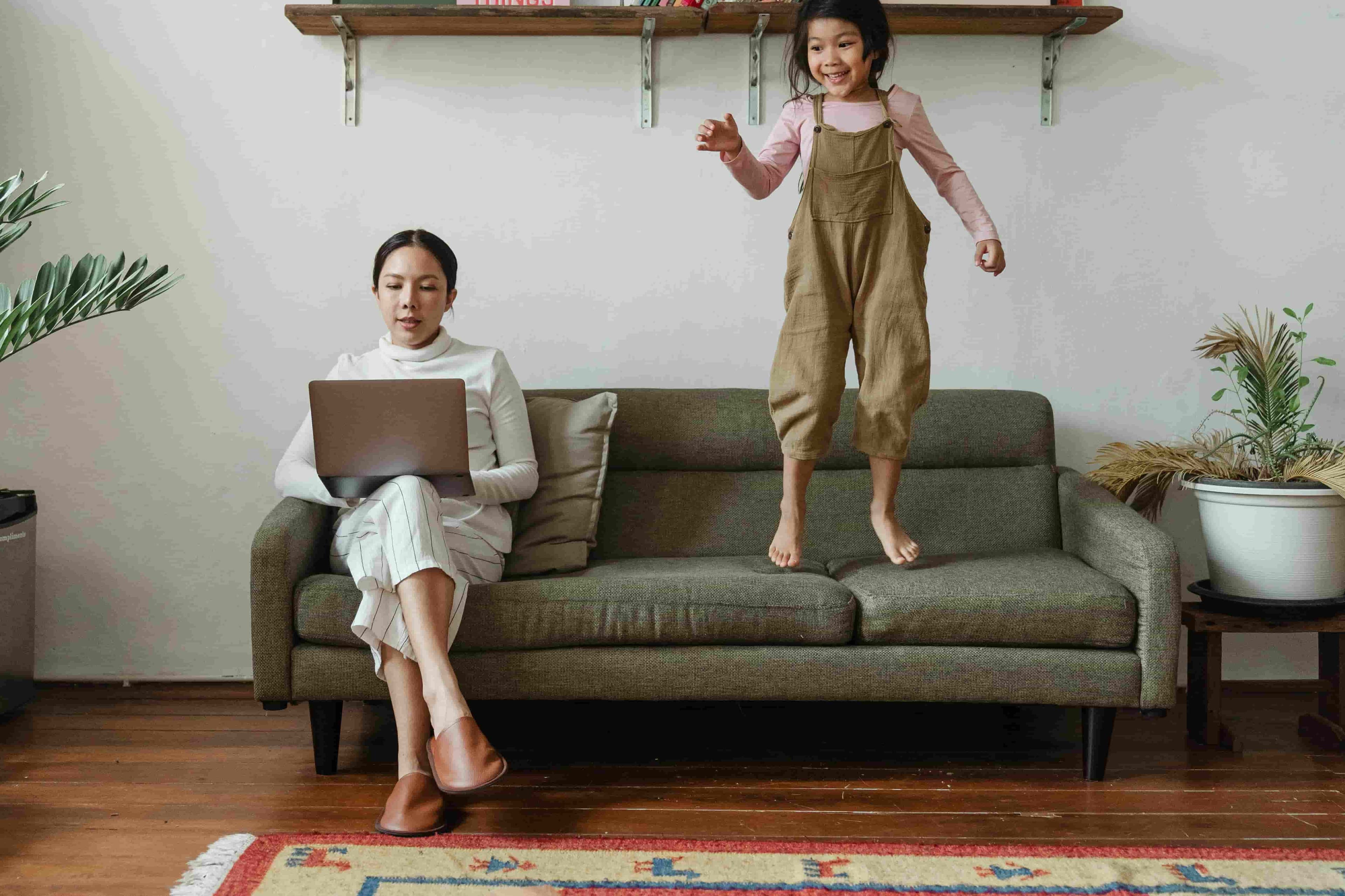 Mother working from home while taking care of her children
