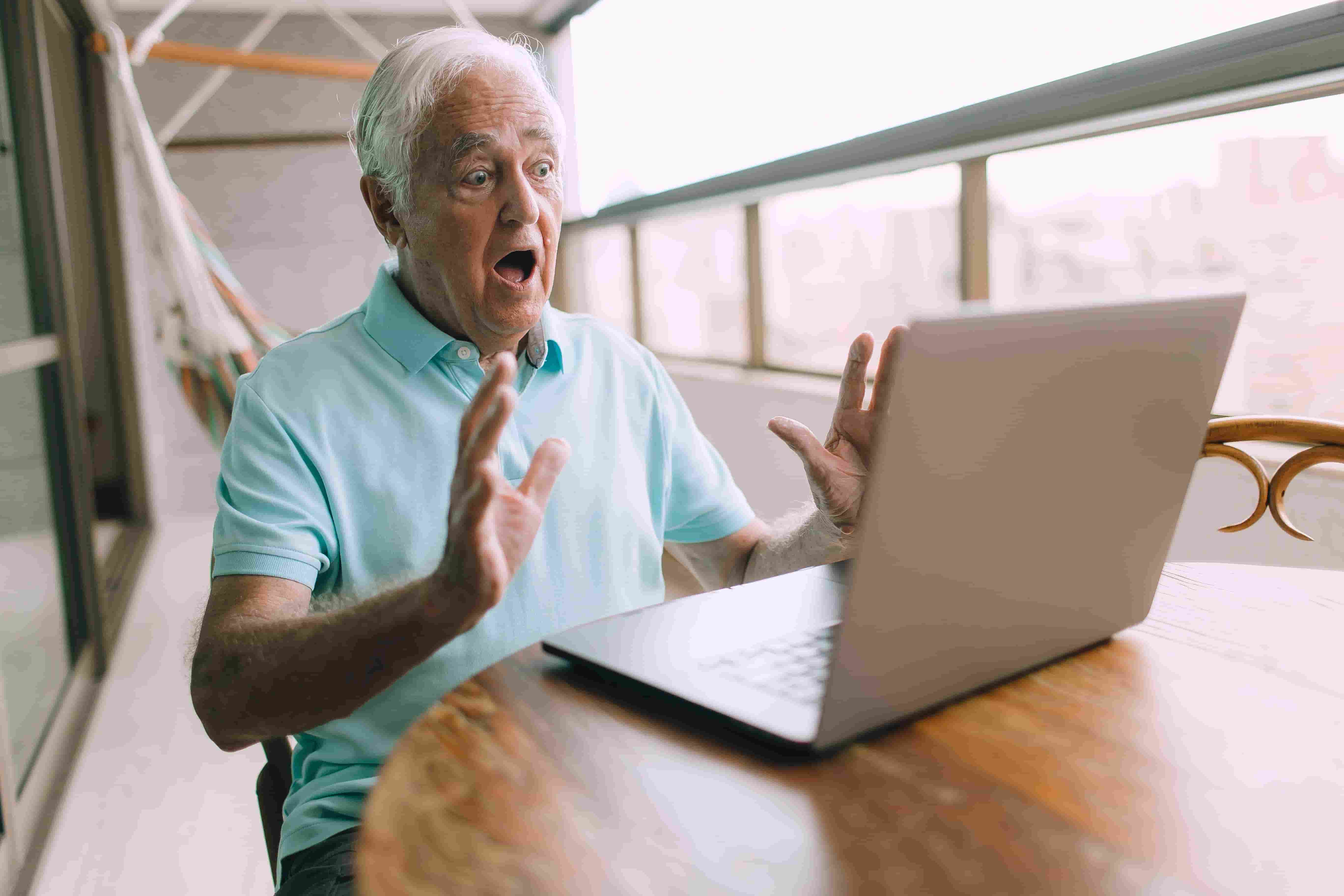 An older man looking confused and worried about his Wi-Fi signal.