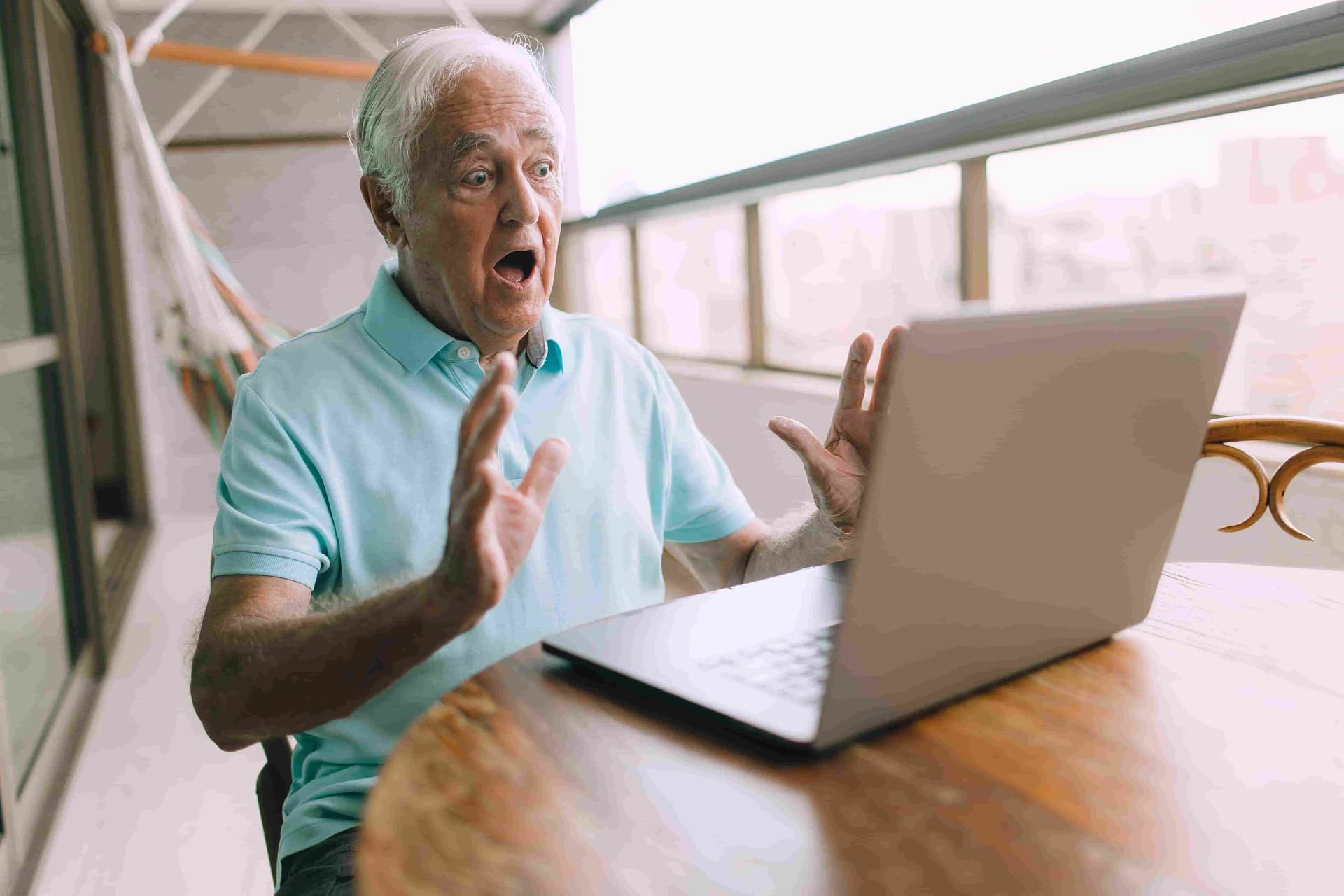An older man looking confused and worried about his Wi-Fi signal.