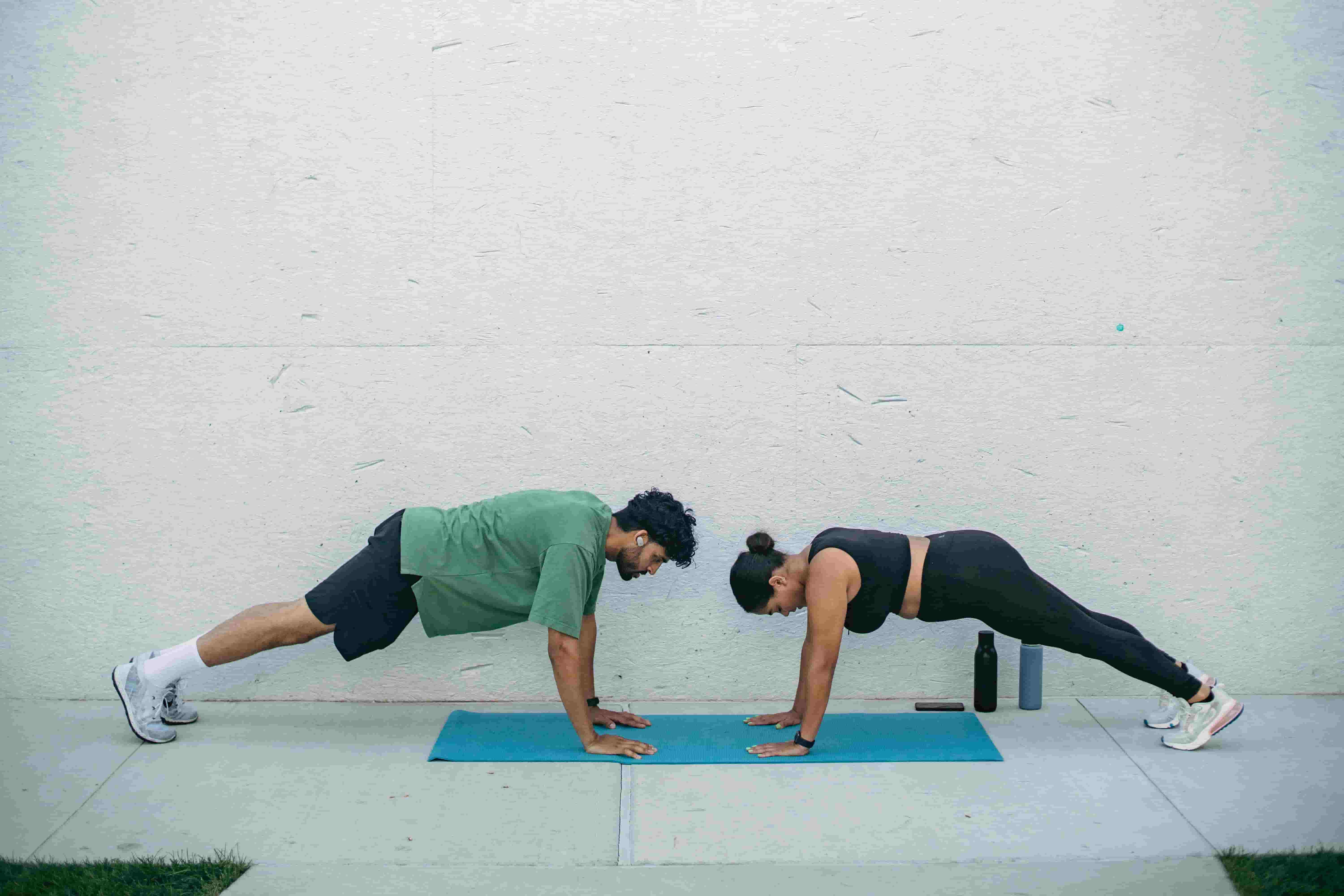 Two people working out together to stay physically healthy